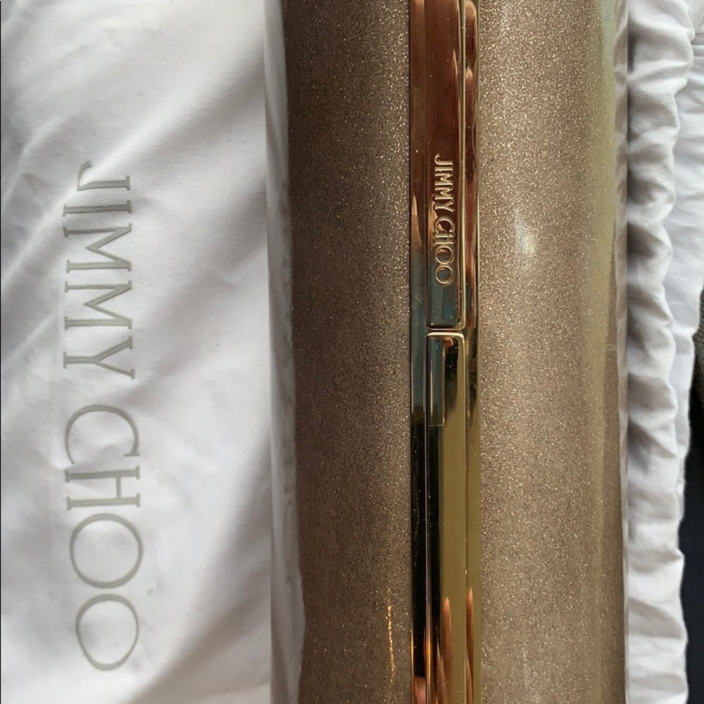 Jummy Choo Gold patent clutch. Barrel shape.